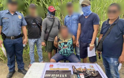 <p><strong>BUSTED</strong>. Local police arrest suspect Elvie J. Paez (seated) in a buy-bust operation conducted in Barangay Palje in San Enrique, Iloilo province on Monday (June 26, 2023). Paez is the Punong Barangay of Barangay Lip-ac, a drug-cleared barangay also in San Enrique. <em>(Photo courtesy of San Enrique MPS)</em></p>