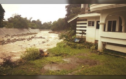 <p><strong>FLOODING.</strong> A house sits precariously on the edge of the Banica River in Dumaguete City in this undated photo. The local government is reviving its Early Warning System amid the El Niño threat. <em>(PNA file photo courtesy of Syril Repe)</em></p>