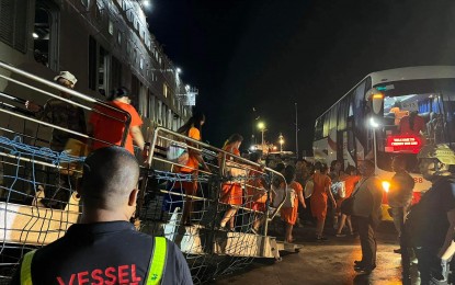 <p><strong>NEW HOME</strong>. Female inmates from the correctional facility in Mandaluyong are directed into a bus after disembarking from M/V St. Francis Xavier on Wednesday night (June 28, 2023) at the port of Puerto Princesa City, Palawan. They are part of an initial batch of 500 inmates from Metro Manila to be transferred to Iwahig Prison and Penal Colony. <em>(Photo by Izza Reynoso)</em></p>
