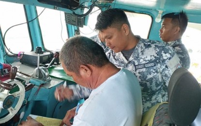 <p><strong>END OF SEARCH.</strong> Philippine Coast Guard personnel aboard fishing boat Ryan Romuald 88 during the transport of rescued fishermen and the bodies of the deceased on Sunday (June 25, 2023) following the sinking of FB Genesis 2 off Baganga, Davao Oriental on June 22, 2023. The PCG has terminated the search and rescue for the six missing fisherfolk. <em>(Photo courtesy of PCG)</em></p>