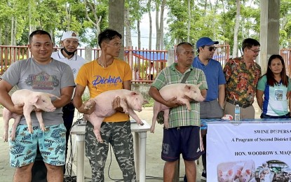 <p><strong>SWINE DISPERSAL.</strong> Negros Oriental Board Member Woodrow Maquiling Sr. (2nd from right) distributes to beneficiaries in Mabinay in this undated photo piglets via his livelihood program. The legislator said the province reported zero ASF cases in the past two weeks. <em>(Photo courtesy of BM Maquiling)</em></p>