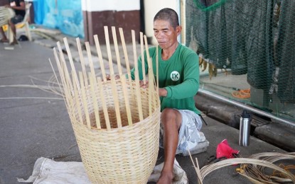 <p><strong>BAMBOO WEAVING</strong>. A farmer in Ilocos Norte shows his skill in weaving bamboo. To further enhance the skills of local weavers, the DTI will organize a skills upgrade training on bamboo processing this July. <em>(Photo courtesy of the City Government of Batac)</em></p>