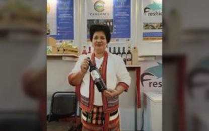 <p><strong>MOUNTAIN WINE</strong>. Carmelita Cabradilla-Abnasan flexes her best-selling Bugnay wine among other fruit wines at the International Trade Expo held last May 24-26, 2023 in Manila. She is set to join another international trade fair in Bangladesh this month. <em>(Contributed Photo)  </em></p>