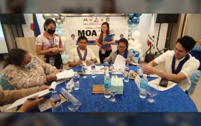 <div><strong>MOA FOR OFWs</strong>. Quezon Public Employment Service Office manager Melojean Puache, Executive Assistant to the Governor John Lozano, OWWA Deputy for Administration and Fund Management Emma Sinclair and Lucena City Mayor Mark Alcala sign a memorandum of agreement between OWWA and local government units on Monday (July 3, 2023) at a restaurant in Lucena City. The memorandum is aimed at helping the OFWs and their families with regard to their various concerns.<em> (Photo by Belinda Otordoz)</em></div>