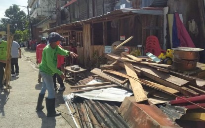 <p><strong>ENCROACHMENT</strong>. A roadside clearing activity in Tacloban City in this undated photo. The Eastern Visayas Regional Development Council has formed a technical working group to address the concerns of informal settlers along national highways in the region. <em>(Photo courtesy of Tacloban city engineering office)</em></p>