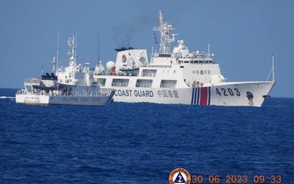<p><strong>BLOCKED. </strong>A much larger vessel of the Chinese Coast Guard blocks the path of the Philippine Coast Guard's BRP Malabrigo (MRRV-4402) during a resupply mission to Ayungin Shoal on June 30, 2023. On June 17, the Chinese rammed a Philippine ship involved in a humanitarian mission to the BRP Sierra Madre stationed in Ayungin Shoal, severely injuring one Navy personnel. <em>(Photo courtesy of Philippine Coast Guard)</em></p>