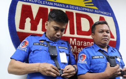 <p><strong>MUST-USE GADGETS.</strong> Metropolitan Manila Development Authority enforcers demonstrate the use of body-worn cameras for traffic management and enforcement operations during a meeting at the MMDA building in Pasig City on Wednesday (July 5, 2023). The meeting presided over by MMDA acting chair Don Artes tackled with stakeholders the drafted rules on the use of the device that will ensure transparency and eliminate paying or taking bribes as all moves will be recorded during apprehensions.<em> (PNA photo by Joan Bondoc)</em></p>