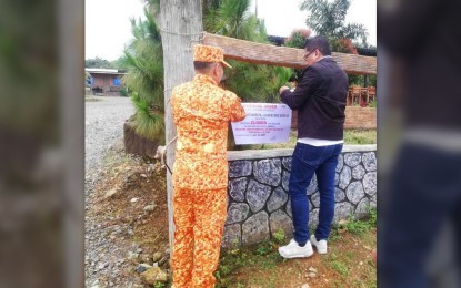 <p><strong>CLOSED</strong>. Mayor Margarito Mission, Jr. and Municipal Fire Marshall Senior Fire Officer II Oliver Dalumpines hang a closure notice at the fence of a resort in Barangay Aningalan in San Remigio town, Antique province on July 5, 2023. In a press conference before the operation, Mission said the closure order was imposed on 46 establishments for their failure to renew business permits and pay taxes. (<em>PNA photo by Annabel Consuelo J. Petinglay</em>)</p>