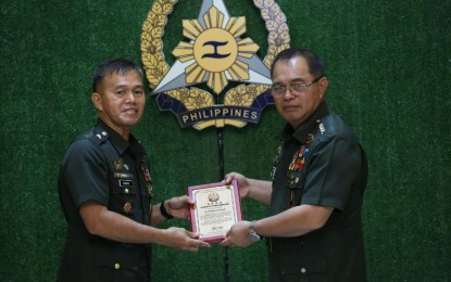 <p><strong>VISCOM AWARDS.</strong> AFP Chief of Staff Gen. Andres Centino hands over one of the awards given to Joint Task Force Storm through 8th Infantry Division commander Lt. Gen. Camilo Ligayo during a simple ceremony on this July 4, 2023 photo. The AFP recognized Viscom’s strong collaboration with the community in the fight against insurgency. <em>(Photo courtesy of Viscom PIO)</em></p>