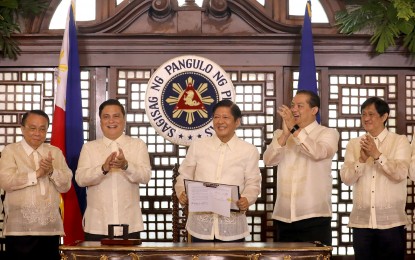 <p><strong>ECONOMIC DEV’T</strong>. President Ferdinand R. Marcos Jr. receives a round of applause after the signing of Republic Act 11593 or the New Agrarian Emancipation Act at Malacañang Palace on Friday (July 7, 2023). Marcos said the condonation of agrarian reform beneficiaries' debt is vital in ensuring food security and economic development. <em>(PNA photo by Rey Baniquet)</em></p>