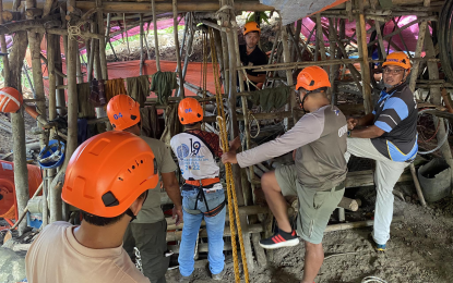 <p><strong>TREASURE HUNTING MISHAP</strong>. Rescuers of Puerto Princesa’s City Disaster Risk Reduction and Management Office stand around an excavation site in Barangay Luzviminda on Wednesday (July 12, 2023). The emergency responders managed to get five unconscious treasure hunters out of the 100-foot-deep hole alive. <em>(Photo courtesy of Earl Timbancaya/CDRRMO)</em></p>