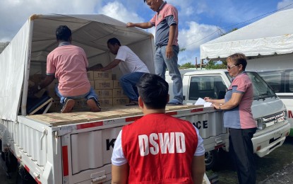<p><strong>FOOD AID.</strong> Workers upload family food packs for residents affected by oil spill in San Ricardo, Southern Leyte in this July 12, 2023 photo. The aid distributed by the Department of Social Welfare and Development (DSWD) to the affected fishermen and their families served as augmentation support to the local government. <em>(Photo courtesy of DSWD)</em></p>