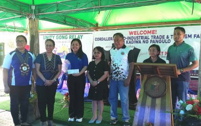 <p><strong>HONOR STUDENT</strong>. Government scholar Aubrey Dominique Bernardez (3rd from left) receives a check worth PHP20,000 from the Bureau of Fisheries and Aquatic Resources - Cordillera for graduating cum laude with a degree in Bachelor of Science in Fisheries from the Cagayan State College in Luna, Apyao on Thursday (July 14, 2023). The BFAR scholarship includes free tuition, a book allowance, a cash stipend, an on-the-job training allowance, and a thesis allowance. <em>(PNA photo by Liza T. Agoot)</em></p>