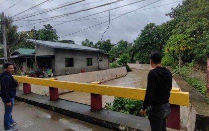 <p><strong>MONITORING</strong>. Local officials monitor the water level of a river in San Nicolas, Pangasinan on Friday (July 14, 2023) as the town has been placed under Tropical Cyclone Wind Signal No. 1 due to Tropical Depression Dodong. The Office of the Civil Defense has raised blue alert status in the entire Ilocos Region. <em>(Photo courtesy of San Nicolas, Pangasinan My Home, My Pride Facebook page)</em></p>