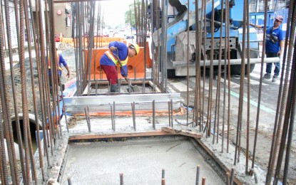 <p><strong>INFRASTRUCTURE PROJECTS</strong>. Construction workers lay cement on the base of an infrastructure project being built along West Avenue in Quezon City July 14, 2023. A report released by First Metro Investment Corporation and the University of Asia and the Pacific expects infrastructure spending to be one of the drivers of economic growth in 2024. <em>(PNA photo by Robert Oswald P. Alfiler)</em></p>