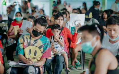 <p><strong>GOV’T AID.</strong> Families in Camalig town, Albay province affected by the ongoing Mayon Volcano unrest receive government aid on Saturday (July 15, 2023) through the Emergency Cash Transfer program of the Department of Social Welfare and Development 5 (Bicol). A total of 5,770 families will receive PHP12,330 each.<em> (Photo courtesy of Camalig Information Office)</em></p>