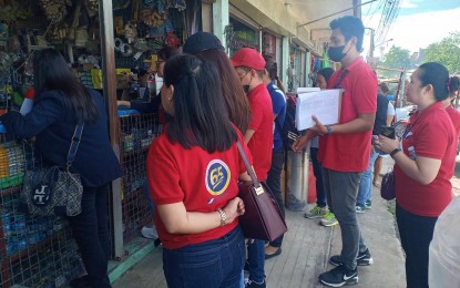 <p><strong>DELINQUENT EMPLOYERS.</strong> Personnel of the Social Security System (SSS) issue a notice to the owner of a hardware store in Tagum City, Davao del Norte, on July 14, 2023, for failure to pay their monthly obligations for their employees. At least 22 delinquent establishments were issued with notices as part of the agency’s “Run After Contribution Evaders” (RACE) campaign<em>. (Photo courtesy of One DavNor Network Facebook Page)</em></p>