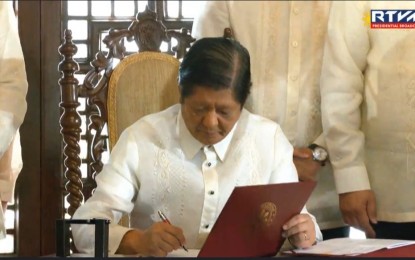 <p><strong>MAHARLIKA FUND.</strong> President Ferdinand R. Marcos Jr. signs Republic Act No. 11954 establishing the Maharlika Investment Fund last July 18, 2023. Marcos said Wednesday (Oct. 10) that the MIF will be operational before the end of year following improvements to its organizational structure and make it “as close to perfect and ideal as possible.”<em> (File photo)</em></p>