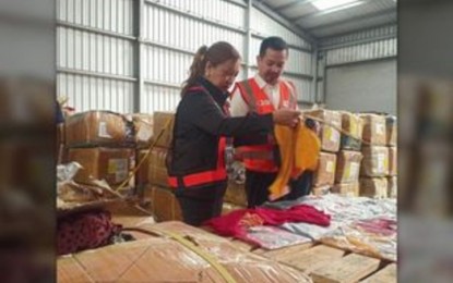 <p><strong>INSPECTION</strong>. SBMA Chairman Jonathan Tan (right) and Bureau of Customs-Port of Subic  District Collector Carmelita Talusan (left), inspect on Tuesday (July 18, 2023) the sample items collected from 1,269 boxes of counterfeit apparels worth PHP240 million which were apprehended at Subic Bay Freeport. The contraband arrived in Subic in two 40-footer container vans last month. <em>(PNA photo by Ruben Veloria)</em></p>
<p> </p>
<p> </p>