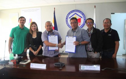 <p><strong>SHELTER PROGRAM</strong>. Department of Human Settlements and Urban Development Assistant Secretary Bryan Villanueva (third from left) and Asingan town Mayor Carlos Lopez Jr. (third from right) pose for a photo on July 18, 2023, after signing the memorandum of understanding for the low-cost housing project to be constructed in Asingan, Pangasinan. The project is the Pambansang Pabahay Para sa Pilipino Housing (4PH) Program. <em>(Photo courtesy of Asingan PIO)</em></p>