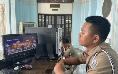 <p><strong>STATE OF THE NATION</strong>. A guard on duty at the Provincial Capitol Building in Laoag, Ilocos Norte watches a live stream of President Ferdinand R. Marcos Jr.'s State of the Nation Address on Monday (July 24, 2023). Farmers, fishers, health workers, and business groups here expressed delight over the President's second SONA. <em>(PNA photo by Leilanie G. Adriano)</em></p>