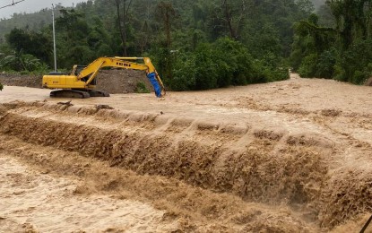 <p><strong>POST-EVACUATION CLEARING</strong>. A backhoe is seen on Monday (July 24, 2023) clearing a flooded bridge in Barangay Salvacion, Puerto Princesa City. Some 89 families were temporarily brought to relocation centers while Typhoon Egay was at its peak. <em>(Photo courtesy of Puerto Princesa City Information Office)</em></p>
