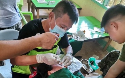 <p><strong> FREE HEALTH SERVICES.</strong> A doctor of the Tagaloguin-Adona Polymedic and Diagnostic Center Incorporated (TAPDCI) administers minor surgery to a patient in Tawi-Tawi Island during the group’s visit to the area on June 12-14, 2023, in coordination with the military’s Western Mindanao Command. The TAPDCI doctors on July 22, 2023 signed a partnership with the Army’s 102nd Infantry Brigade in Zamboanga Sibugay to treat some 8,000 brigade soldiers, auxiliary force units, and former rebels in the province.<em> (Photo courtesy of TAPDCI)</em></p>