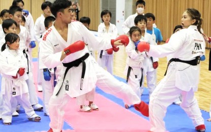 <p><strong>WORLD-CLASS ATHLETE.</strong> Filipino-Japanese Junna Tsukii (left) shows children the right technique during a karate class in Japan. Tsukii won the women's -50kg gold medal at the 2022 World Games in Birmingham, United States. <em>(Contributed photo)</em></p>