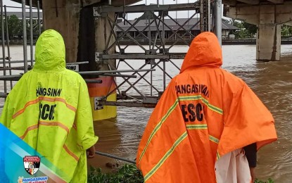 <p><strong>MONITORING.</strong> Personnel of the Pangasinan Provincial Disaster Risk Reduction and Management Office monitor the water level of a river system in Pangasinan on Wednesday (July 26, 2023) as Typhoon Egay continues to batter Luzon. A total of 46 families have been evacuated in Pangasinan as of 11 a.m. (<em>Photo courtesy of Pangasinan PDRRMO</em>)</p>