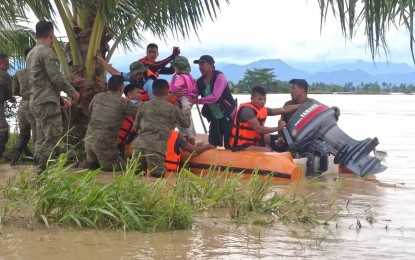 <p><strong>TO THE RESCUE.</strong> Troops of the Philippine Army's 77th Infantry Battalion, together with personnel of the Philippine National Police, mount rescue operations in Baggao, Cagayan at the height of Typhoon Egay on Thursday (July 27, 2023). The Armed Forces of the Philippines has deployed land, naval and air units to conduct rescue and relief operations in areas battered by the typhoon. <em>(Photo courtesy of Philippine Army)</em></p>