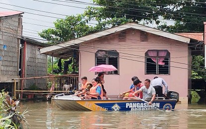 <p><strong>BOAT RIDE.</strong> Residents are ferried from their residences as floodwaters continue to rise in Calasiao, Pangasinan on Saturday (July 29, 2023). The town is under a state of calamity since July 28.<em> (Photo courtesy of Calasiao CDRRMO)</em></p>