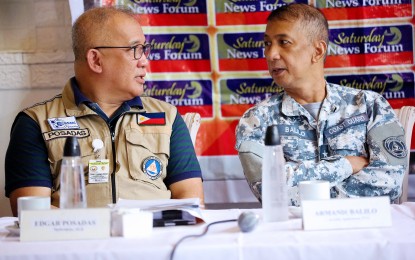 <p><strong>SERIOUS TALK</strong>. Rear Admiral Armand Balilo (right), Philippine Coast Guard spokesperson, and Edgar Posadas, spokesperson of the Office of Civil Defense, exchange views during the Saturday News Forum at the Dapo Restaurant and Bar in Quezon City on July 29, 2023. In a radio interview on Tuesday (Dec. 5, 2023), Balilo said the PCG has placed all its assets on "heightened alert" in Mindanao, the Visayas, and some parts of Luzon after the bomb explosion at the Mindanao State University in Marawi City. <em>(PNA photo by Robert Oswald P. Alfiler)</em></p>