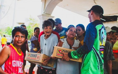 <p><strong>RELIEF. </strong>Residents of Barangay San Pedro in Narvacan town, Ilocos Sur receive family food packs from the Department of Social Welfare and Development on July 29,2023. The DSWD has already augmented over 89,000 family food packs and non-food items to the affected families in Ilocos Region as of August 1. <em>(Photo courtesy of Pablo Sanidad II Facebook page)</em></p>