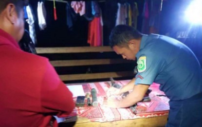 <p><strong>SEIZED FIREARMS.</strong> A police officer accounts for the war materiel seized by government forces during the serving of an arrest warrant against a wanted communist rebel in Magpet, North Cotabato Tuesday (Aug. 1, 2023). The subject of the warrant, Romeo Betil, eluded arrest. (<em>Photo courtesy of PRO-12)</em></p>