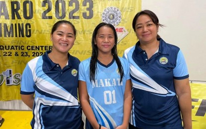 <p><strong>TRIPLE GOLD WINNER</strong>. National Capital Region swimmer Krystal Ava David (center) poses with Colegio San Agustin Makati and Golden Sea Eagles Swim Team head coach Doll Disini-De Guzman (right) and assistant coach Kate Sinio in this undated photo. David has already won three gold medals, including 50m breaststroke in record fashion at Marikina Sports Center on Wednesday (Aug. 2, 2023). <em>(Contributed photo)</em></p>