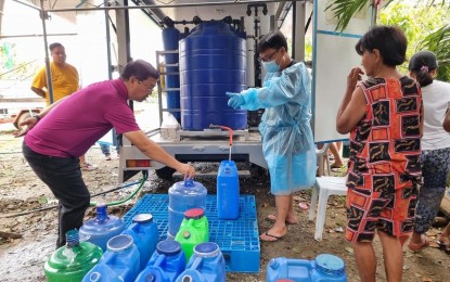 <p><strong>WATER FILTRATION</strong>. Batac City Mayor Albert Chua checks the rollout of the water filtration system in Batac City on July 30, 2023. The mobile water filtration and purification system is one of the priority projects of the local government to safeguard the health of local communities after massive floodings. <em>(Photo courtesy of the city government of Batac)</em></p>