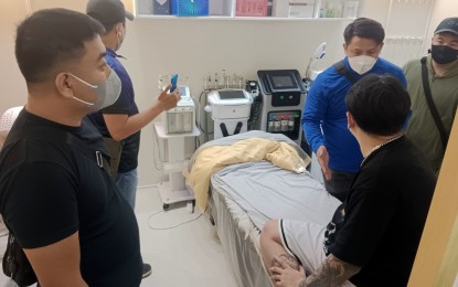 <p><strong>NABBED.</strong> CIDG-NCR agents arrest 34-year-old Haitao Gong (seated, in black shirt) for engaging in medical practice without a license, during an entrapment inside his clinic in Makati City on July 31, 2023. Gong will face charges for violation of Republic Act 2382 or The Medical Act of 1959. <em>(Photo courtesy of CIDG)</em></p>