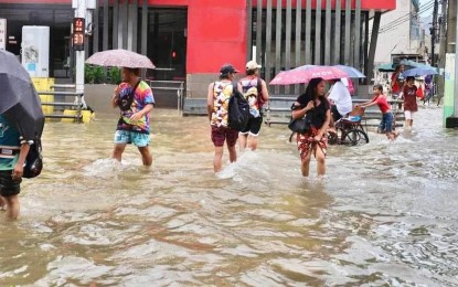 <p><strong>FLOOD</strong>. Residents in Dagupan City wade through a flooded road on Wednesday (Aug. 2, 2023). The Department of Health warned residents against getting exposed to floods to avoid getting infected with leptospirosis and other water-borne diseases. <em>(Photo courtesy of Mayor Belen Fernandez Facebook page)</em></p>
