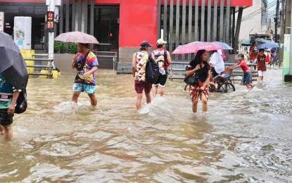 <p><strong>FLOOD.</strong> Residents in Dagupan City wade through the flooded road on Aug. 2,2023. The Department of Health said the Food and Drug Administration has expedited the clearance of 1 million capsules of doxycycline to prevent leptospirosis. <em>(Photo courtesy of Mayor Belen Fernandez Facebook page)</em></p>