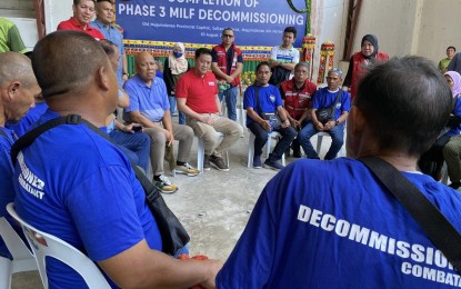 <p><strong>DECOMMISSIONED COMBATANTS.</strong> Department of Social Welfare and Development Secretary Rex Gatchalian (seated, center in red polo shirt) engages decommissioned combatants of the Moro Islamic Liberation Front (MILF) in an open dialogue during the resumption of the Phase 3 Decommissioning of MILF members in Sultan Kudarat, Maguindanao del Norte on Aug. 4, 2023. Gatchalian also led the distribution of PHP100,000 cash assistance. <em>(Photo courtesy of DSWD)</em></p>