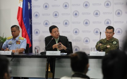 <p>National Security Council Assistant Director General Jonathan Malaya <em>(center)</em></p>