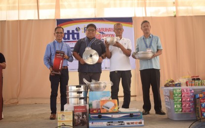 <p><strong>LIVELIHOOD KITS</strong>. Ronald Paguigan (2nd from left), a beneficiary of the Department of Trade and Industry's (DTI) "Pangkabuhayan sa Pagbangon at Ginhawa" Program in Ligao City, is grateful for the food processing kit he received on Tuesday (Aug. 8, 2023). The beneficiaries were among the entrepreneurs affected by the Covid-19 pandemic and calamities that hit the Bicol region. <em>(Photo courtesy of DTI-Bicol)</em></p>