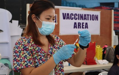 <p><strong>VACCINATION.</strong> A health worker prepares a Covid-19 booster vaccine at a health center in Dumaguete City, Negros Oriental province in this undated photo. Health authorities are urging residents to avail of the 3rd booster dose bivalent vaccine which is designed to fight the Omicron variant of Covid-19 but can now be used as a regular booster shot. <em>(Photo by Judy Flores Partlow)</em></p>