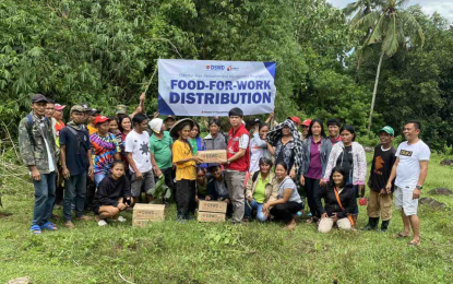 <p><strong>FOOD FOR WORK.</strong> Some of the residents in Negros Oriental pose for posterity after joining the Food-For-Work program of the Department of Social Welfare and Development (DSWD) in Central Visayas in this undated photo. The DSWD-7 distributed a total of PHP6.3 million worth of family food packs to over 10,000 breadwinners who joined the program in Central Visayas. <em>(Photo courtesy of DSWD-7)</em></p>