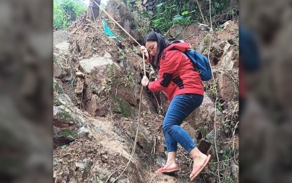 <p><strong>‘ANGEL IN RED’</strong>. An employee of the Department of Social Welfare and Development-Cordillera rappels from a tree in Barangay Gumatdang in Itogonm Benguet province to check on internally displaced residents affected by Super Typhoon Egay. DSWD personnel like her have come to be known as "angels in red" as they brave the elements clad in bright red vests to reach communities hit by calamities and bring munch needed assistance. <em>(PNA photo from DSWD-CAR FB)</em></p>