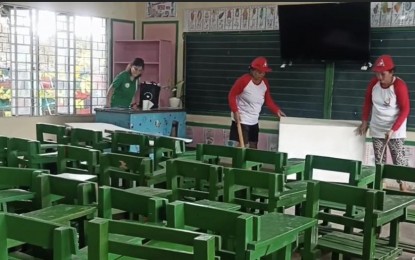 <p><strong>PARTNERS</strong>. Beneficiaries of the Department of Labor and Employment's Tulong Panghanapbuhay sa Ating Disadvantaged/Displaced (TUPAD) from six towns in Tarlac participate in the ongoing Brigada Eskwela to serve as partners of parents and teachers in cleaning school facilities. Some 800 TUPAD beneficiaries were deployed in 36 public schools around the province. <em>(Photo courtesy of DOLE Tarlac Provincial Office)</em></p>