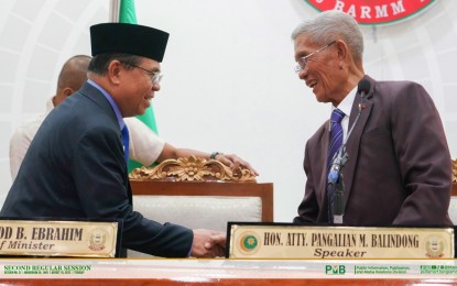 <p><strong>BILLS ENACTMENT.</strong> BARMM Chief Minister Ahod Balawag Ebrahim (left) and Bangsamoro Transition Authority (BTA) Speaker Pangalian Balindong greet each other after the legislature’s Chief Minister Hour on Tuesday (Aug. 15, 2023) at the regional government center in Cotabato City. Ebrahim called on the BTA to enact important pieces of legislative measures.<em> (Photo courtesy of BTA-BARMM)</em></p>