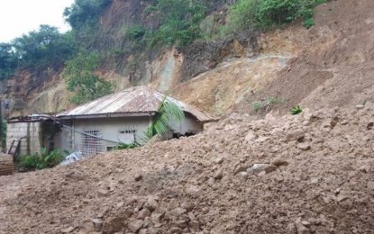<p><strong>LANDSLIDE</strong>. A portion of a mountain which was used to be a quarry site in Sitio Riverside, Pulangbato, a hinterland village of Cebu City almost covered a house, in this Wednesday (Aug. 16, 2023) photo taken by the Disaster Risk Reduction and Management Office. Six families were evacuated to safer ground. <em>(Photo courtesy of Cebu City PIO)</em></p>
