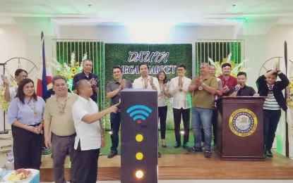 <p><strong>FREE WI-FI.</strong> Mayor Galicano Truita of Dauin, Negros Oriental (foreground in white shirt) leads the switch-on ceremony of the free Wi-Fi at the Dauin mega market on Thursday (Aug. 17, 2023). The activity was part of the soft opening of the multi-million pesos modern market that boasts a hotel, an elevator, commercial office spaces for rent, and more than 100 stalls. <em>(Photo by Judy Flores Partlow)</em></p>