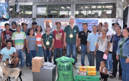 <p><strong>AID TO ANIMAL RAISERS</strong>. Negros Occidental Governor Eugenio Jose Lacson (center) leads the distribution of hog cholera vaccine doses and dispersal of animals as an alternative livelihood for animal raisers in the southern part of the province in rites in Ilog town on Thursday (Aug. 17, 2023). Some 70,400 doses of hog cholera jabs have been procured by the province, of which 25,000 doses have initially been delivered.<em> (Photo courtesy of PIO Negros Occidental)</em></p>